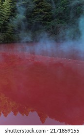 beautiful scenes of Japan nature. red volcanic lake with steam. hot lake with bright beautiful color. beautiful green forest around