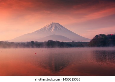 Beautiful scenic landscape of mountain Fuji or Fujisan with reflection on Shoji lake at dawn with twilight sky in Yamanashi Prefecture, Japan. Famous travel and camping in 1 of 5 Fuji lakes. - Shutterstock ID 1450515365