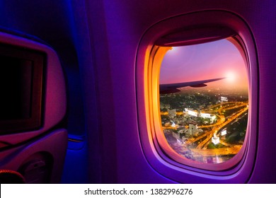 Beautiful scenic night city view through the aircraft window. Image save-path for window of airplane.