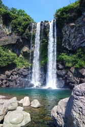 The Beautiful Scenic Panorama View Of Jeongbang Waterfall And Blue Water, A Famous Waterfall On Jeju Island That The Only Water Fall In Asia That Falls Directly Into The Ocean. South Korea.