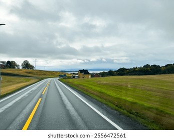 Beautiful scenic route winding through vibrant autumn scenery towards a majestic snow-capped mountain summit against a backdrop of clear blue skies - Powered by Shutterstock