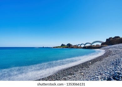 Beautiful Scenic Of Sanxiantai Arch Bridge With Blue Ocean With Three Saint Island In Behind At Chenggong District In Taitung City, Taiwan.