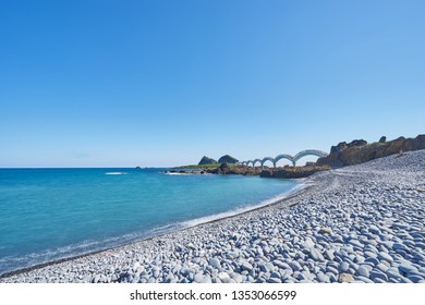 Beautiful Scenic Of Sanxiantai Arch Bridge With Blue Ocean With Three Saint Island In Behind At Chenggong District In Taitung City, Taiwan.