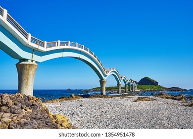 Beautiful Scenic Of Sanxiantai Arch Bridge With Blue Ocean With Three Saint Island In Behind At Chenggong District In Taitung City, Taiwan.