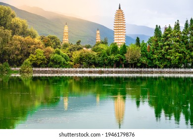 Beautiful scenic view of Dali Three Pagodas of Chongsheng Temple with water reflection and dramatic light in Dali Yunnan China