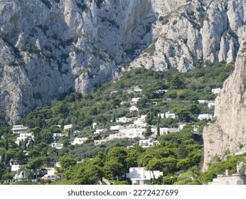  Beautiful scenic view of a mountain base neighborhood village with homes located in a coastal valley landscape in Europe along the Amalfi coast.            - Powered by Shutterstock