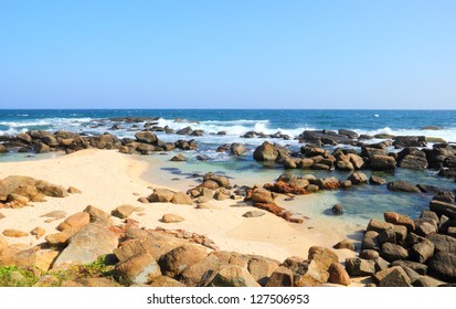 Beautiful Scenic View Of The Wild Rocky Beach With Calm Water Of Indian Ocean Against The Background Of Clear Blue Sky In Dondra, Sri Lanka Island, South Asia