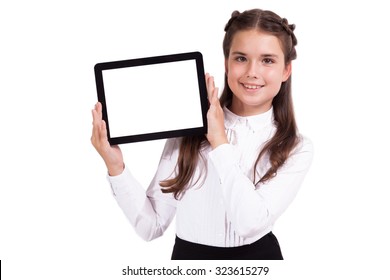Beautiful school girl in a business suit holds a horizontal tablet in his hands and looking into the camera, Selective focus on the tablet