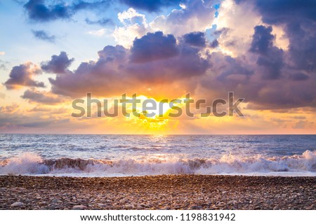 beautiful sea landscape with a sunset. evening purple sky with clouds over ocean. sea surf with waves