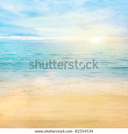 Beautiful sea summer or spring abstract background. Golden sand beach with blue ocean and cloudscape and sunset in the back.