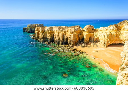 beautiful sea view with secret sandy beach among rocks and cliffs near Albufeira in Algarve, Portugal