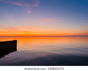 Beautiful seascape after the sunset, purple and orange sky after the sunset, calm sea horizon