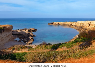 Beautiful seascape with cliffs and turquoise sea in Cyprus. Rocky shoreline with a body of water in the distance - Powered by Shutterstock