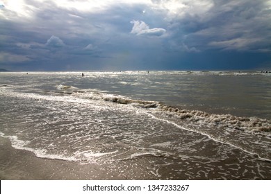 Beautiful Seascape With Cloudy Sky In The English Channel, Deauville Beach. France. Tide. Rough Sea. People Swim In The Sea. Cloudy Day