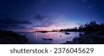 Beautiful seascape with colorful sky. Sunset and night time on the rock beach.