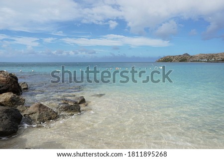 Beautiful seascape featuring the turquoise water and white sandy beach at Cockleshell Bay, St. Kitts. West Indies.