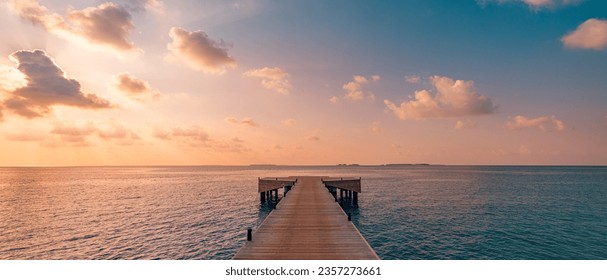 Beautiful seascape long jetty pier at sunset. Minimal sea sky, calm water surface and reflections. Colorful peaceful sunrise tones orange, gold, blue. Tranquil relaxing panoramic inspire meditation - Powered by Shutterstock