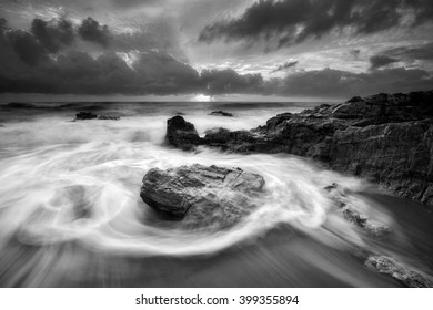 Beautiful seascape with motion waves during sunrise in black and white. 