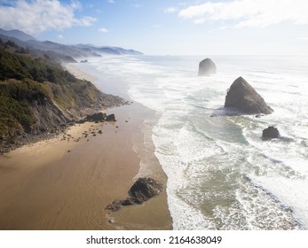 Beautiful Seascape. In The Ocean There Are Stones Located In A Row, A Sandy Shore And Rocks. Blue Sky With Light White Clouds. Beauty Of Nature, Calm Scenes. Travel Destinations, Tourism.