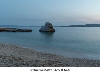 Beautiful seascape, rock in Adriatic sea near Baska Voda in Croatia at summer dusk. Ikovac beach - Shutterstock ID 2093553295