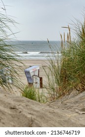 beautiful seascape with sand dunes and grass as its main subject, the sea is out of focus this seascape was filmed on the north german island of Norderney  - Shutterstock ID 2136746719