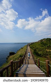 a beautiful seascape with a seaside walkway, against charming clouds, scenery around mt. songak