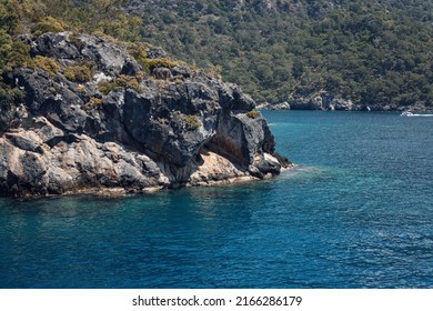 Beautiful Seascape. Travel Concept. Seascape On The Background Of The Wild Rocky Coast. Wild Beach, Azure Water And Rocks. Luxury Summer Adventure, Aegean Sea, Turkey. Postcard View. Steep Rocky Shore