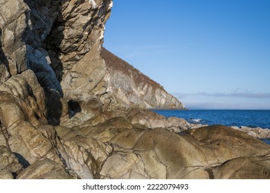 Beautiful seascape. View of the rocky sea coast and cape. There is no one on the seashore. Majestic cliff and rocks. Travel to the Russian Far East. Coast of the Sea of Okhotsk, Magadan region, Russia