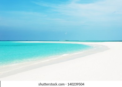 Beautiful Seascape With White Sand On The Beach And Blue Water On The Sea