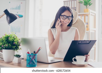 Beautiful secretary in spectacles is checking her boss`s meeting to arrange another one. She is friendly and smiling - Shutterstock ID 628172654