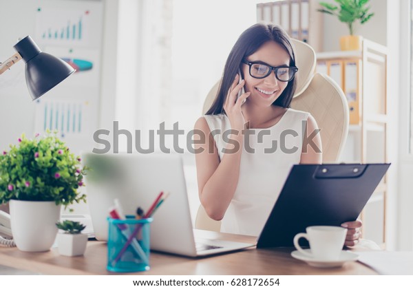 Beautiful\
secretary in spectacles is checking her boss`s meeting to arrange\
another one. She is friendly and\
smiling