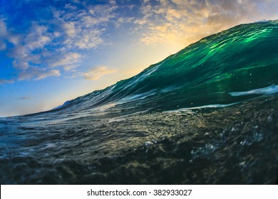 Beautiful Semitransparent Seascape At Sunset Time. Big Surfing Translucent Green Ocean Wave With Sun Spot. Marine Sport Water Surface.