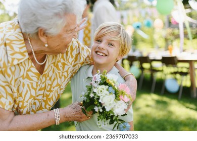 Beautiful senior birthday woman receiving flowers from grandson. - Powered by Shutterstock