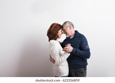 Beautiful Senior Couple In Love Dancing. Studio Shot.