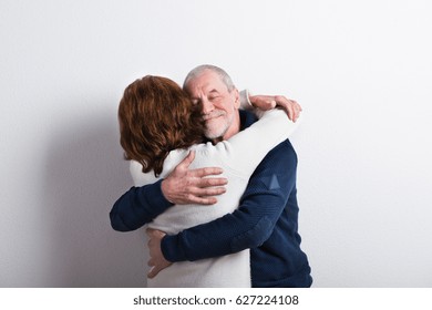 Beautiful Senior Couple In Love Hugging. Studio Shot.