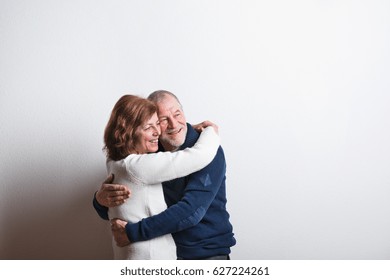 Beautiful Senior Couple In Love Hugging. Studio Shot.