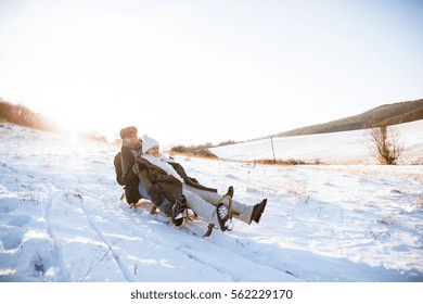 Beautiful Senior Couple On Sledge Having Fun, Winter Day.