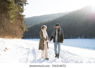 Beautiful Senior Couple On A Walk On Sunny Winter Day