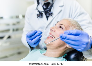 Beautiful Senior Woman At Dentist Having Dental Treatment At Dentist's Office.