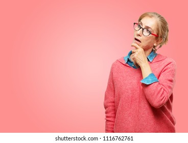 Beautiful Senior Woman With A Goofy, Dumb, Silly Look, Feeling Shocked And Confused At A Recent Realization, Not Really Understanding An Idea.