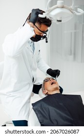 Beautiful Senior Woman Having Dental Treatment At Dentist's Office. Dentist Is Wearing Protective Face Mask Due To Coronavirus Pandemic.	