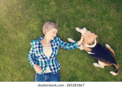 Beautiful senior woman lying on a grass in a park