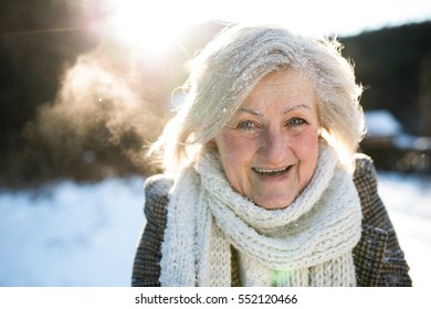 Beautiful Senior Woman On A Walk, Covered By Snow