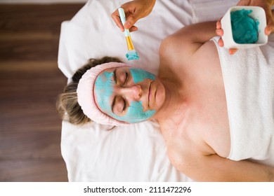 Beautiful Senior Woman Receiving A Facial Treatment And A Mud Mask At The Beauty Spa 