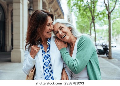 Beautiful senior women bonding outdoors in the city - Attractive cheerful mature female friends having fun, shopping and bonding, concepts about elderly lifestyle - Powered by Shutterstock