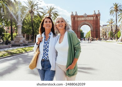 Beautiful senior women bonding outdoors in the city - Attractive cheerful mature female friends having fun, shopping and bonding, concepts about elderly lifestyle - Powered by Shutterstock