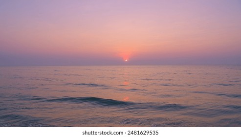 Beautiful Serene Ocean Sunrise over a calm ocean with a soft pink and purple sky, Gentle Waves and Calm Horizon, Tranquil and Peaceful Nature Scenes, Beach and Relaxation Concepts - Powered by Shutterstock