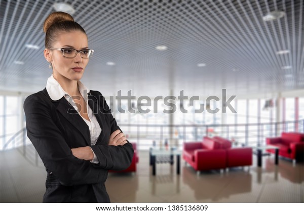 Beautiful serious business woman with glasses\
on empty dealer center\
background
