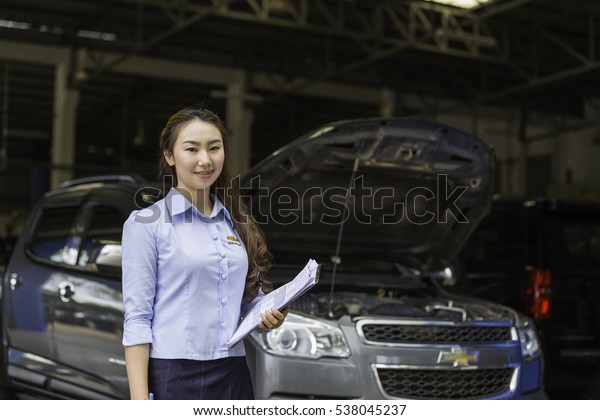 Beautiful service adviser smile at\
Certified Service garage. After Sale Service Chevrolet-Lao at\
Vientiane Capital, Laos. photo were taken on November 9\
2016.