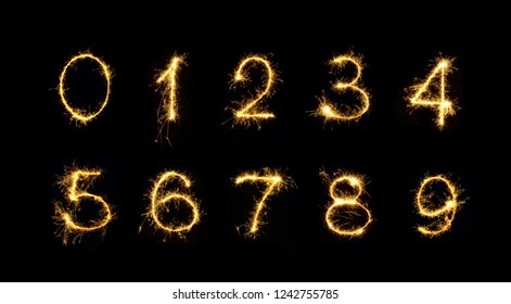 Beautiful Set Of Fireworks Numbers 0, 1, 2, 3, 4, 5, 6, 7, 8, 9. Burning Sparkler Numbers Isolated On Black Background. Numbers Of Sparklers To Overlay On Texture For Design